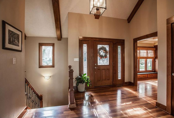 Craftsman entryway with a finished staircase and trim work