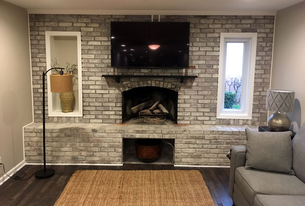 Finished family room with a fireplace and built-in shelving