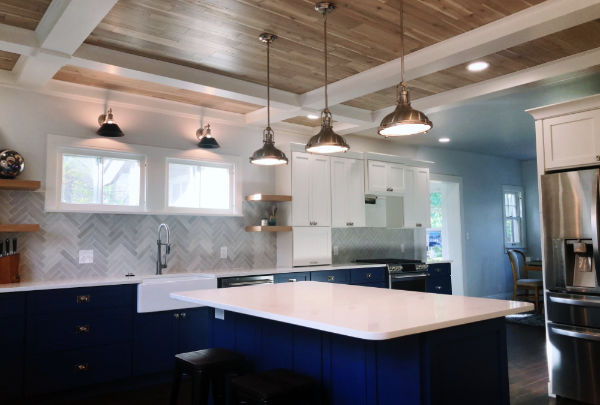 Remodeled kitchen with white cabinetry and a centre island